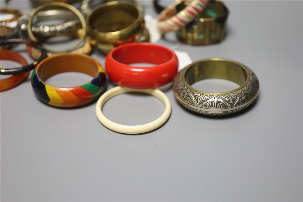 A collection of bangles, including five ethnic white metal examples,